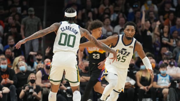 Utah Jazz guard Jordan Clarkson (00) and Utah Jazz guard Donovan Mitchell (45) slap hands during the second half of the game against the Phoenix Suns at Footprint Center.